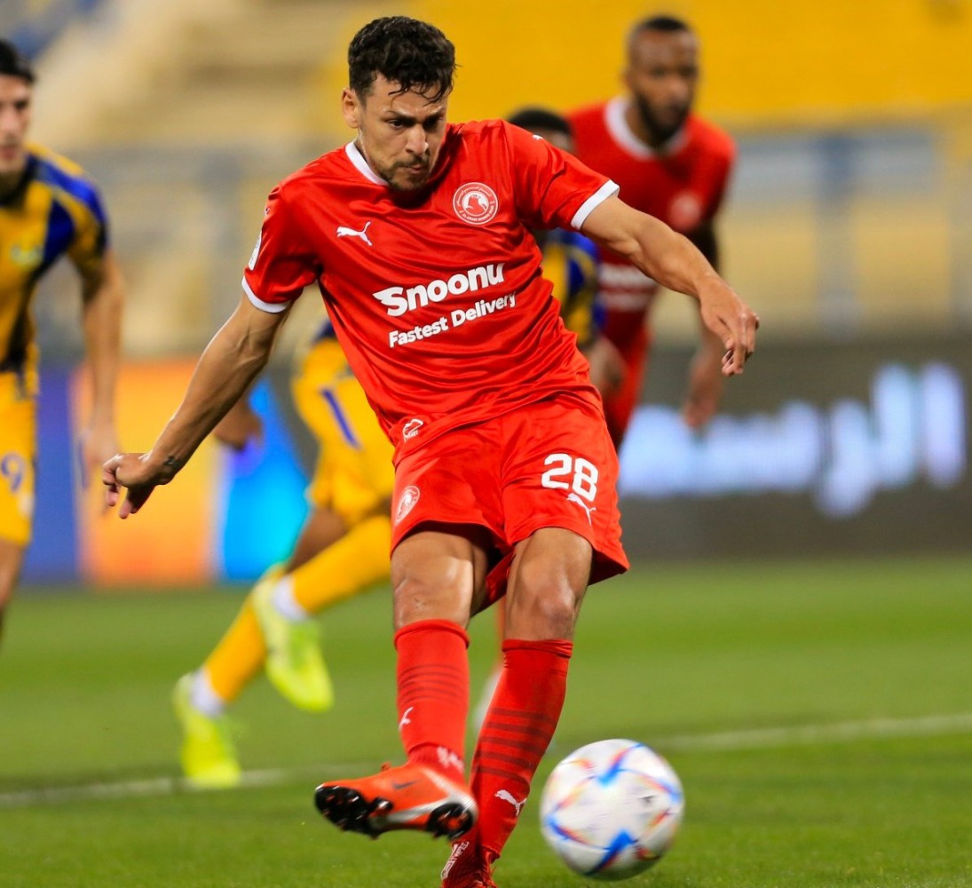 Al Arabi's Youssef Msakni shoots from the penalty spot to score a goal against Al Gharafa.