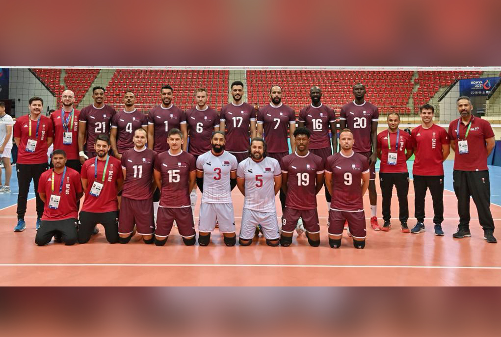 Qatar volleyball team players and officials pose for a photograph. 