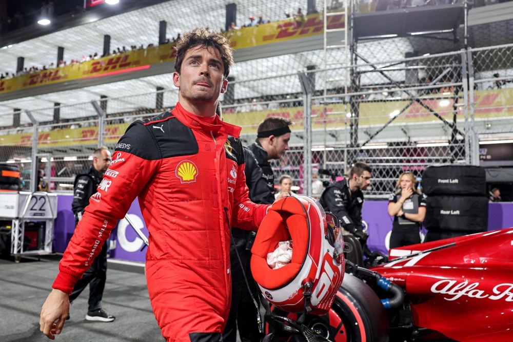 Ferrari's Monegasque driver Charles Leclerc walks along the pit lane ahead of the Saudi Arabia Formula One Grand Prix at the Jeddah Corniche Circuit in Jeddah on March 19, 2023. (Photo by Giuseppe Cacace / AFP)