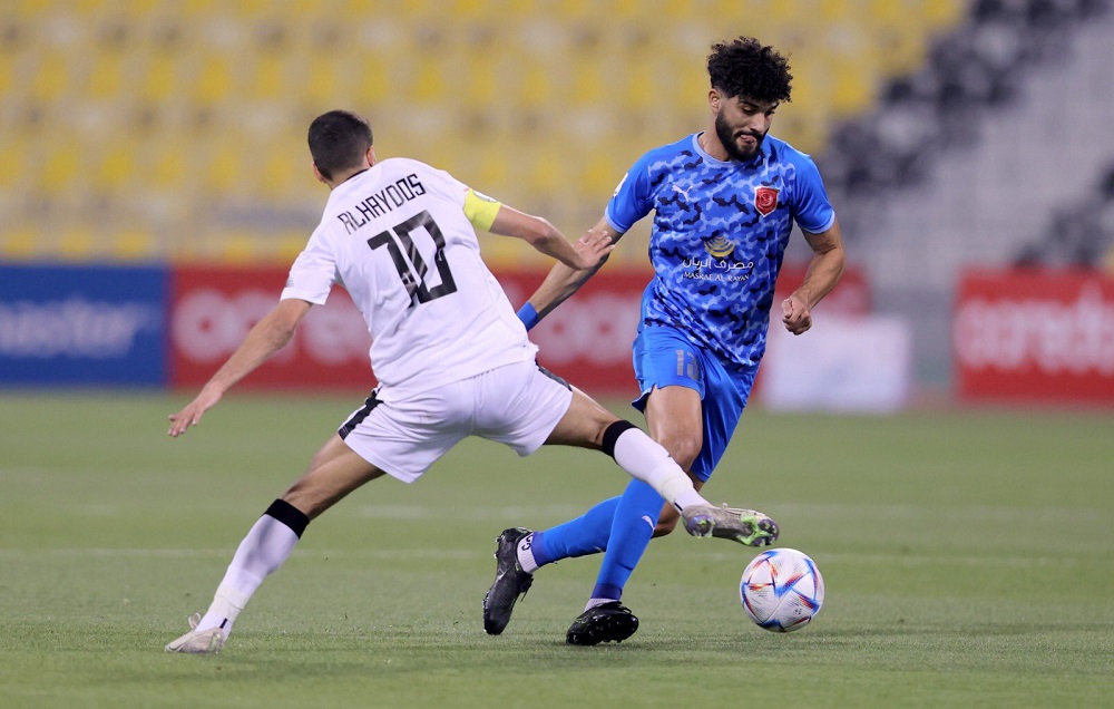 Al Duhail's Ferjani Sassi in action against Al Sadd captain Hassan Al Haydos during their semi-final.