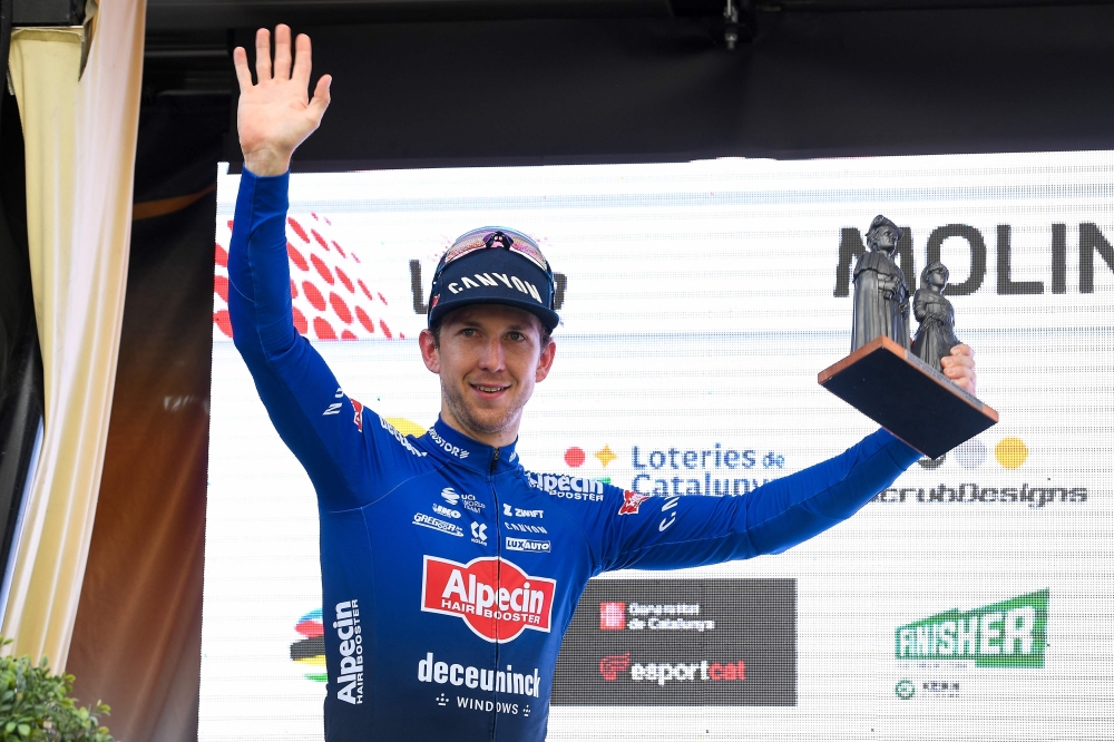 Stage winner Alpecin-Deceuninck's Australian rider Kaden Groves celebrates with the trophy on the podium after the 6th stage of the 2023 Volta Catalunya cycling tour of Catalonia, a 183 km race from Martorell to Molins de Rei, on March 25, 2023. (Photo by Josep LAGO / AFP)