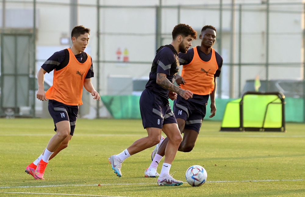 Al Duhail's South Korean midfielder Nam Tae-Hee (left) with teammates during a training session.