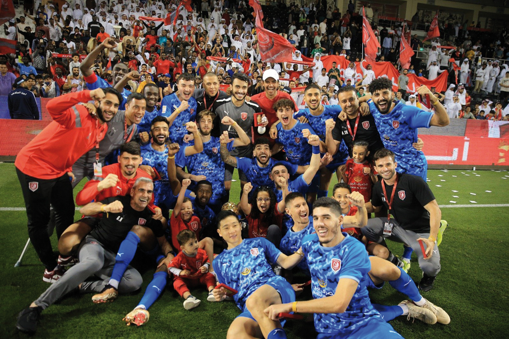 Al Duhail players and officials celebrate after winning the Ooredoo Cup final.