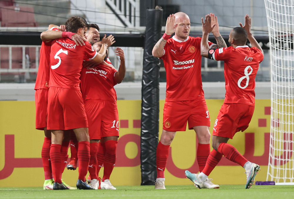 Al Arabi players celebrate their second goal yesterday. 