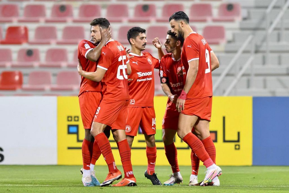 Al Arabi's Youssef Msakni (second left) celebrates with team-mates after scoring a goal yesterday.  