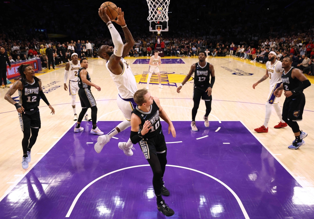 LeBron James #6 of the Los Angeles Lakers scores over Luke Kennard #10 of the Memphis Grizzlies during Game Three of the Western Conference First Round Playoffs at Crypto.com Arena on April 22, 2023 in Los Angeles, California.  Harry How / Getty Images via AFP
