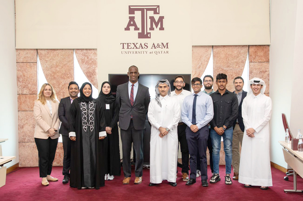 US Ambassador to Qatar H E Timmy T Davis poses with Texas A&M University students and faculty.