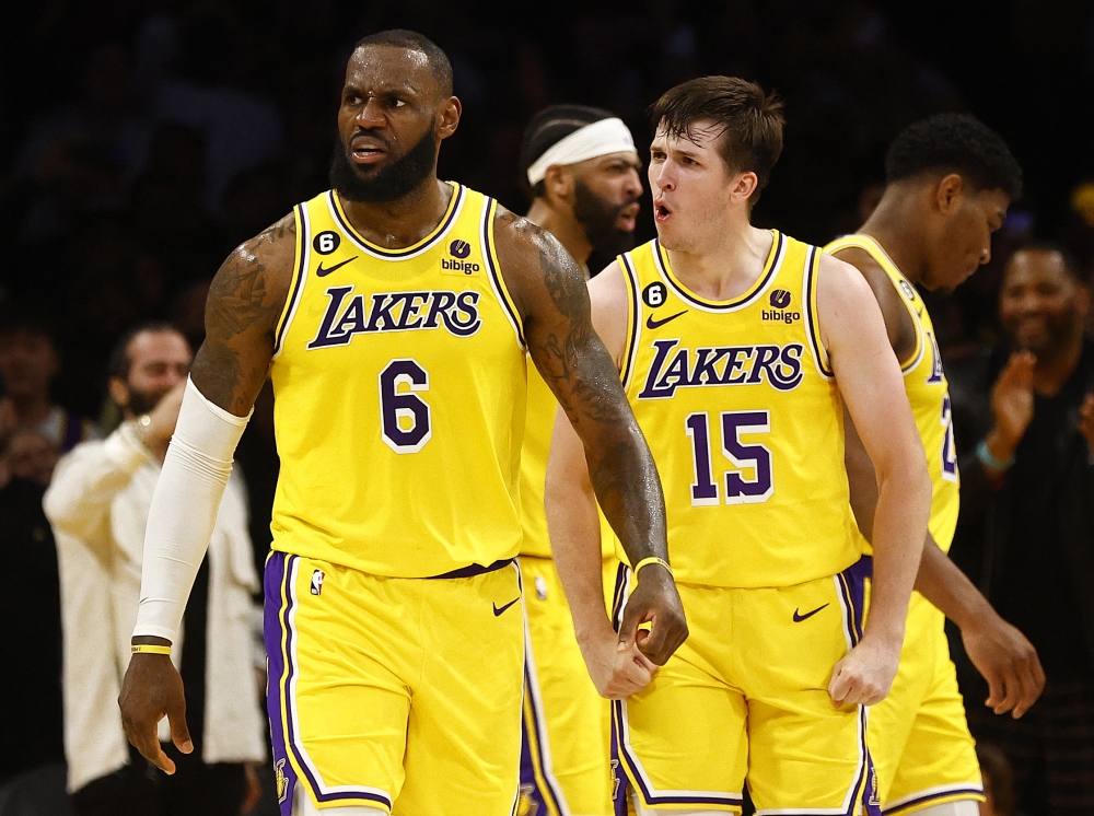 LeBron James #6 and Austin Reaves #15 of the Los Angeles Lakers react against the Memphis Grizzlies in overtime of Game Four of the Western Conference First Round Playoffs at Crypto.com Arena on April 24, 2023 in Los Angeles, California.  Photo by RONALD MARTINEZ /  Getty Images via AFP