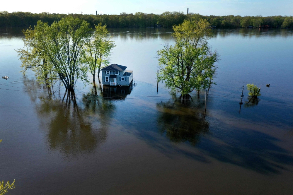 In this aerial, a home is surrounded by floodwater from the Mississippi River on May 03, 2023 in Albany, Illinois. Scott Olson/Getty Images/AFP 