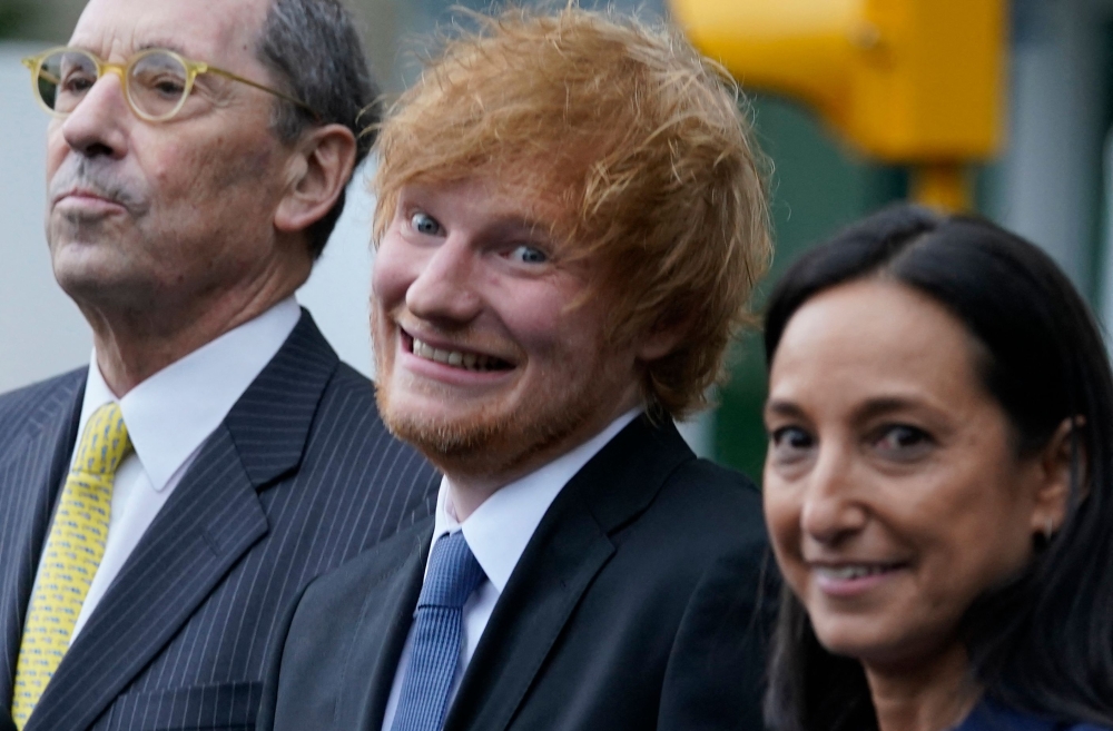 British singer-songwriter Ed Sheeran (centre) departs Manhattan Federal Court in New York, on May 4, 2023. (Photo by TIMOTHY A. CLARY / AFP)

