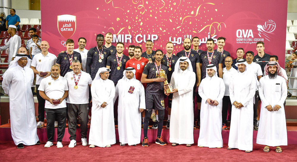 Qatar Olympic Committee (QOC) President H E Sheikh Joaan bin Hamad Al Thani presents the Amir Cup winners' trophy to Al Rayyan skipper Mubarak Dahi Waleed  after the Lions defeated Al Arabi in the final at the Ladies Sports Hall in Aspire Zone yesterday.