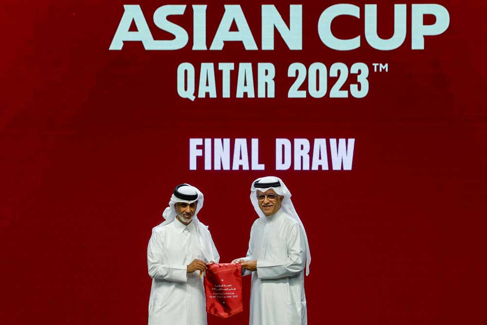 Qatar Football Association’s President Sheikh Hamad bin Khalifa bin Ahmed Al Thani (left) and President of the Asian Football Confederation (AFC) Shaikh Salman bin Ebrahim Al Khalifa pose for a picture during the draw for the AFC Asian Cup in Doha yesterday. (AFP)