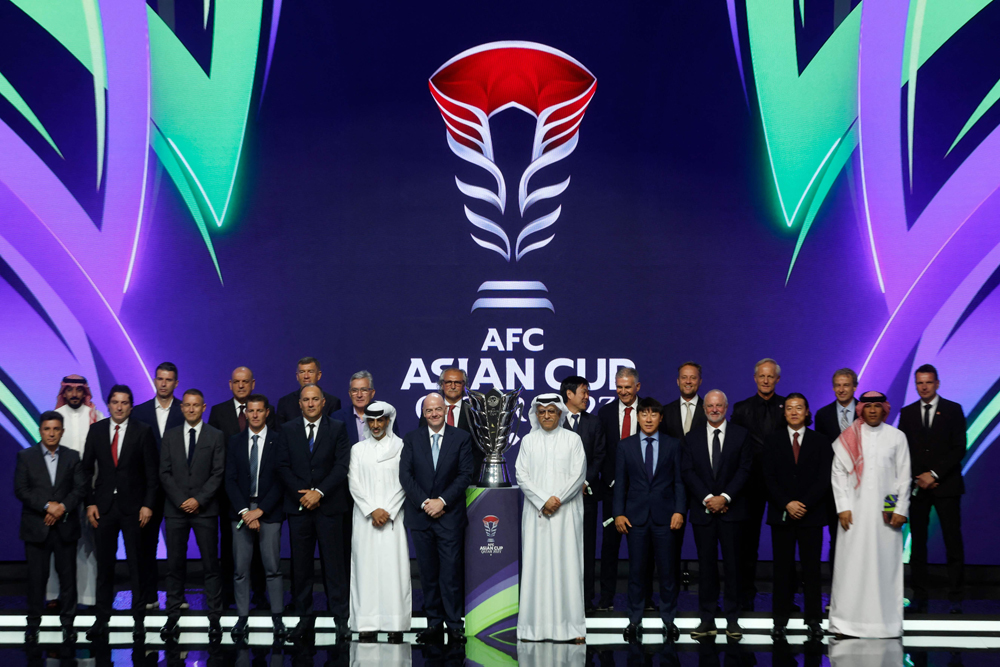 QFA President Sheikh Hamad bin Khalifa bin Ahmed Al Thani, FIFA President Gianni Infantino and AFC President Shaikh Salman bin Ebrahim Al Khalifa along with coaches pose for a picture with the trophy after the Draw. PICS: AFP