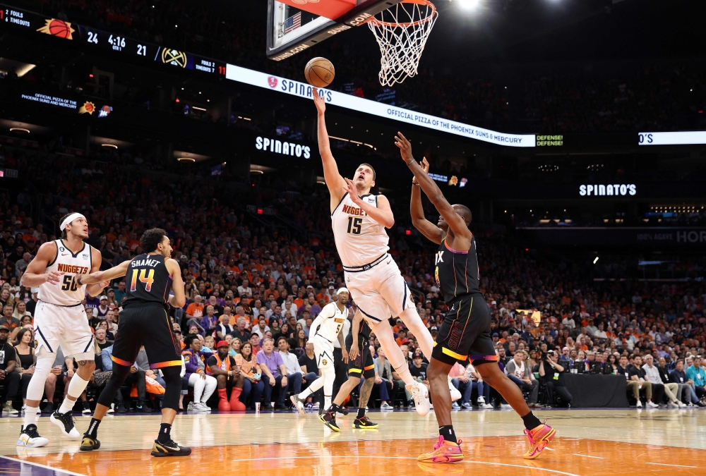 Nikola Jokic #15 of the Denver Nuggets drives to the basket during the first quarter against the Phoenix Suns in game six of the Western Conference Semifinal Playoffs at Footprint Center on May 11, 2023 in Phoenix, Arizona. (Photo by Christian Petersen / GETTY IMAGES NORTH AMERICA / Getty Images via AFP)