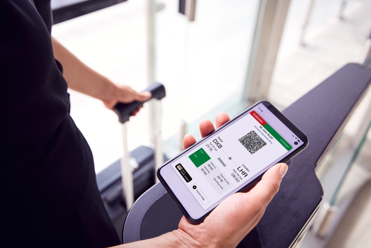 Close up of a passenger in airport looking at digital boarding pass on smart phone. Source: Emirates website 