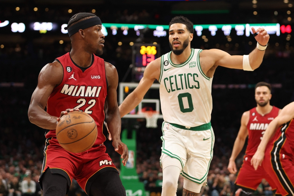 Jimmy Butler #22 of the Miami Heat is defended by Jayson Tatum #0 of the Boston Celtics during the third quarter of game one of the Eastern Conference Finals at TD Garden on May 17, 2023 in Boston, Massachusetts.  Photo by Adam Glanzman / AFP