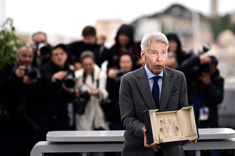 US actor Harrison Ford poses with his Honorary Palme d'Or during a photocall for the film 