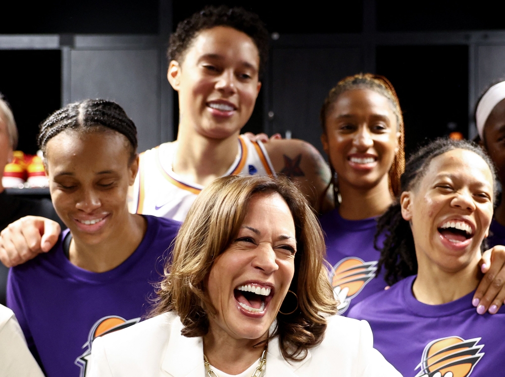 US Vice President Kamala Harris (C) laughs while standing with Brittney Griner (TOP) and other members of the Phoenix Mercury in the locker room before their game against the Los Angeles Sparks at Crypto.com Arena on May 19, 2023 in Los Angeles, California. Mario Tama/Getty Images/AFP 