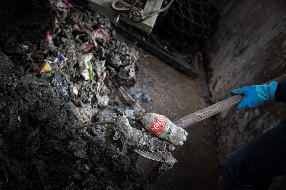 This photograph shows waste trapped by a net from a rainwater outlet channel, in Rouen, north-western France, on March 28, 2023. Photo by Lou BENOIST / AFP