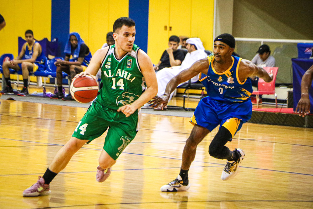 Al Ahli's Christos Bratsiakos dribbles past Al Gharafa's Byron Kelly Ashe during their Amir Cup Group 1 match, yesterday.