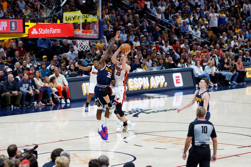 Duncan Robinson #55 of the Miami Heat drives to the basket against Jeff Green #32 of the Denver Nuggets during the fourth quarter in Game Two of the 2023 NBA Finals at Ball Arena on June 04, 2023 in Denver, Colorado. Justin Edmonds/Getty Images/AFP 