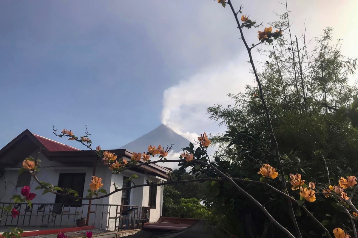 This handout photo made available by Kristin Moral shows Mount Mayon spewing white smoke as seen from Camalig on June 8, 2023. (Photo by Handout / Kristin Moral / AFP) 