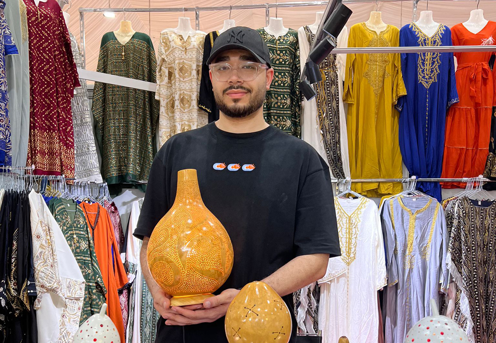 Amrou Mohamed with his gourd lamps.