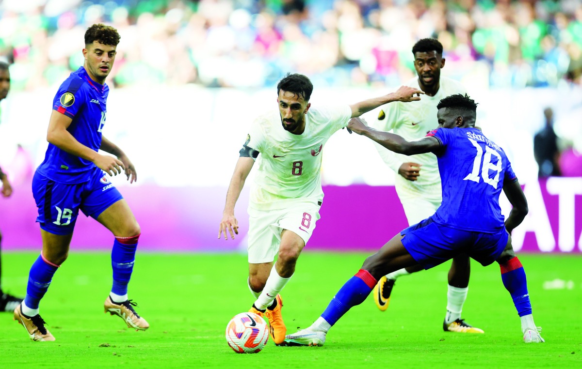 Qatar's Ali Asad (left) in action during the match against Haiti, yesterday.