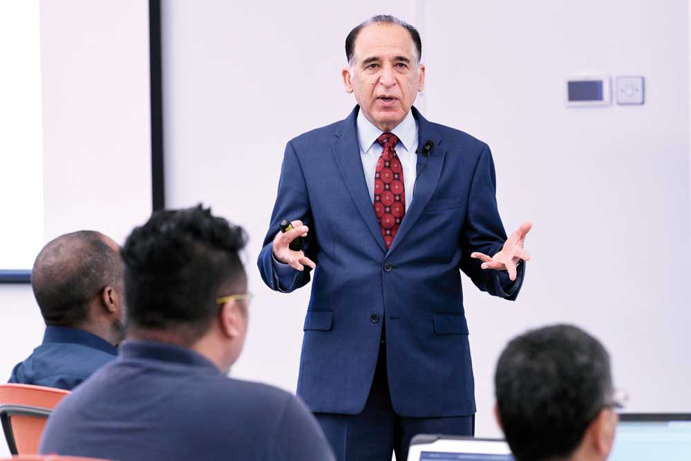 Dr. Ravinder Mamtani speaking to participants during a workshop.