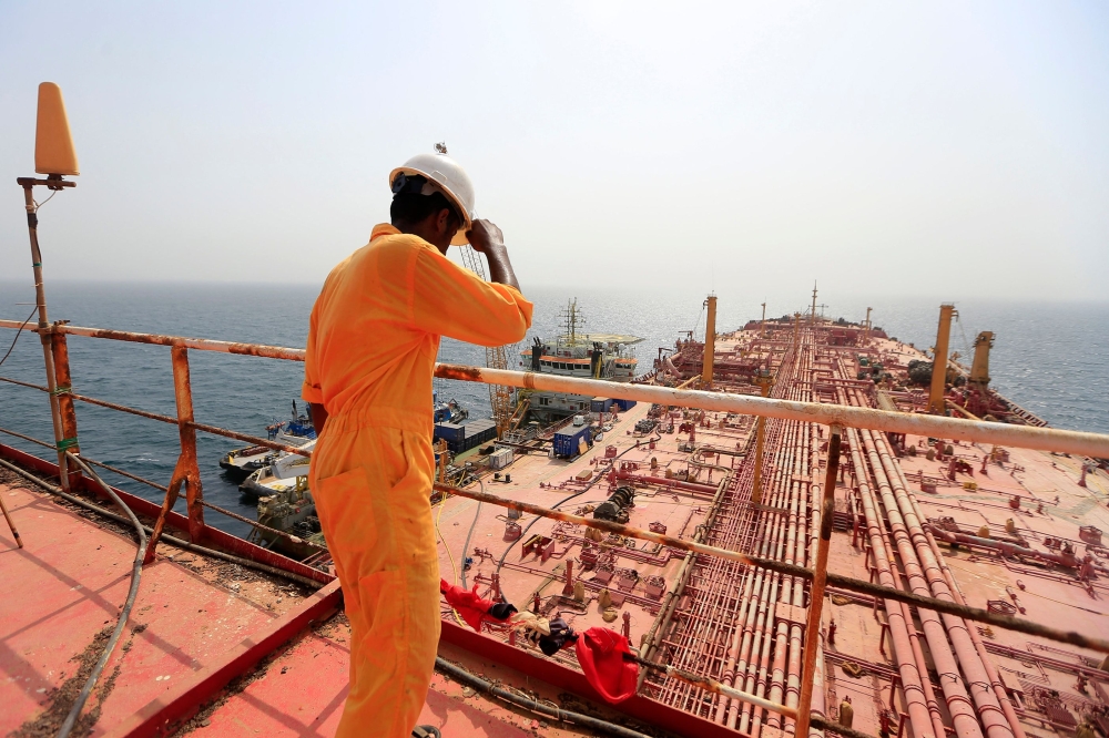 A man stands on the deck of the beleaguered Yemen-flagged FSO Safer oil tanker, in the Red Sea off the coast of Yemen's contested western province of Hodeida on June 12, 2023. (Photo by Mohammed Huwais / AFP)