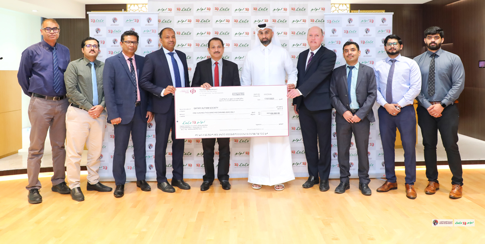 Shaijan MO, Regional Director of Lulu Group, presenting a donation of QR100,000 to Mohammad Faisal, Executive Director of the Qatari Autism Society. 