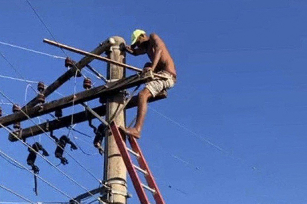 This handout picture released by the Minas Gerais Fire Department show a fugitive climbed on an electric pole while escaping from the police in the town of Itabira, Brazil on August 5, 2023. (Photo by Handout / Minas Gerais Fire Department / AFP) 