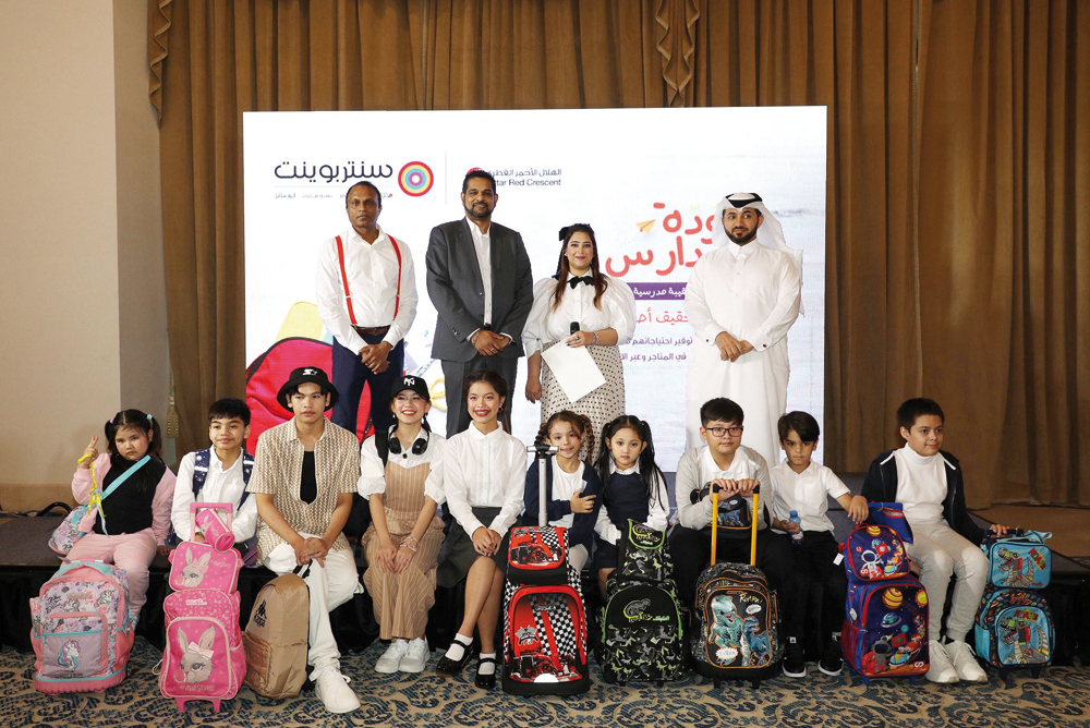 Representatives of Landmark Group Qatar, Shumalan Naicker (second left), Territory Head; Raj Gopal (left), Senior Marketing Manager; with Abdul Aziz (right), a senior official from Qatar Red Crescent, pose with child models during the preview of ‘back to school' collection’ by Centrepoint. Pics: Salim Matramkot/The Peninsula