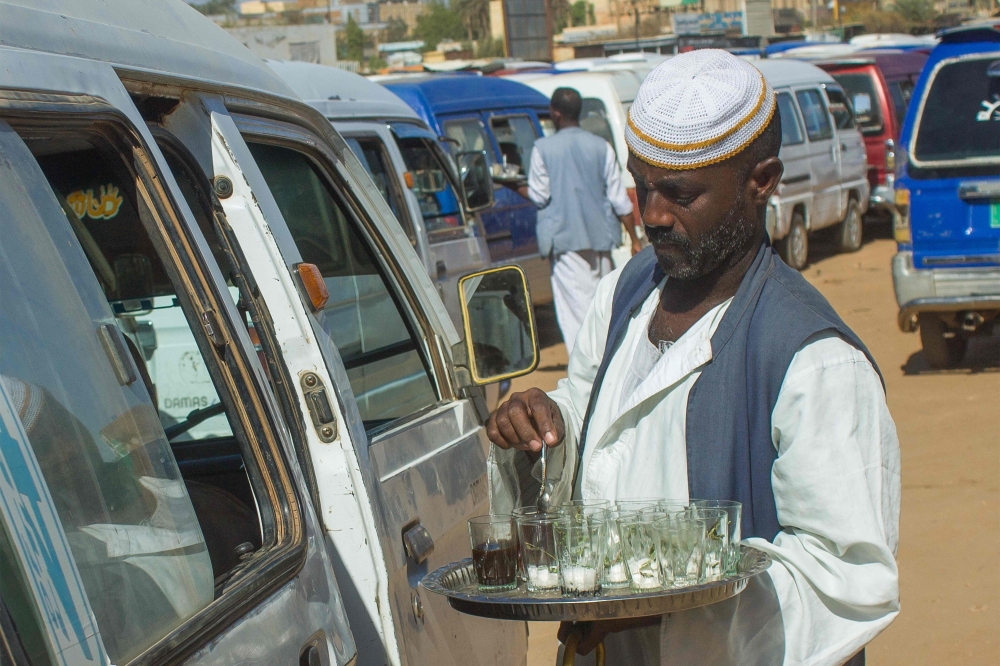 (Files) A street vendor sells tea at a bus station in Madani on May 16, 2023. (Photo by AFP)