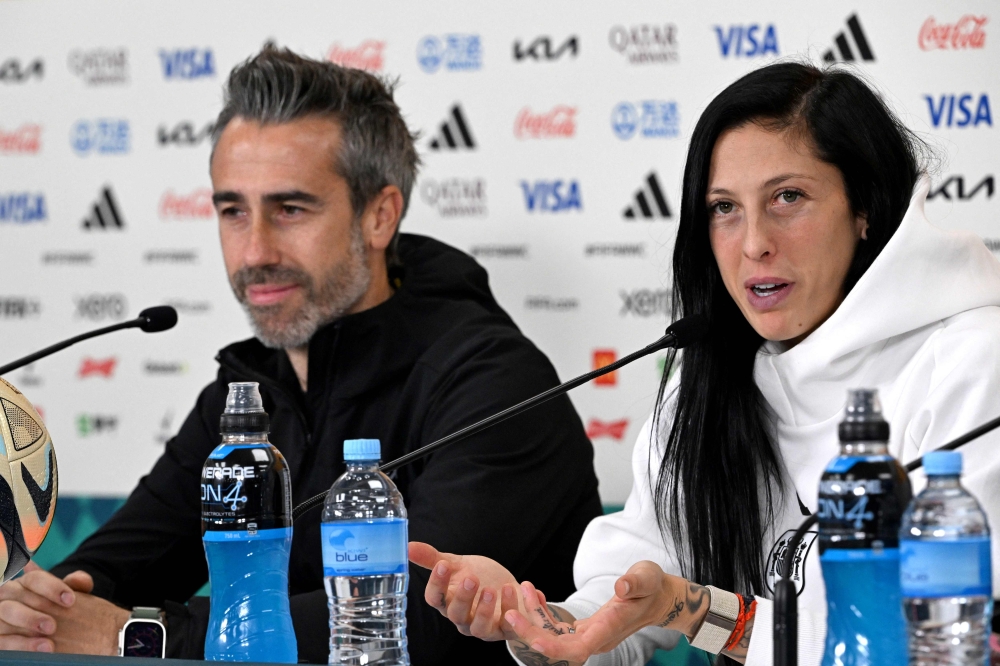 Team Spain head coach Jorge Vilda (L) and player Jennifer Hermoso attend a press conference at Eden Park in Auckland on August 14, 2023. (Photo by Saeed Khan / AFP) 