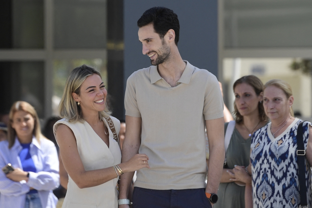 PSG Spanish goalkeeper Sergio Rico with his wife Alba Silva after leaving the hospital in Seville on August 18, 2023. (Photo by Cristina Quicler / AFP)