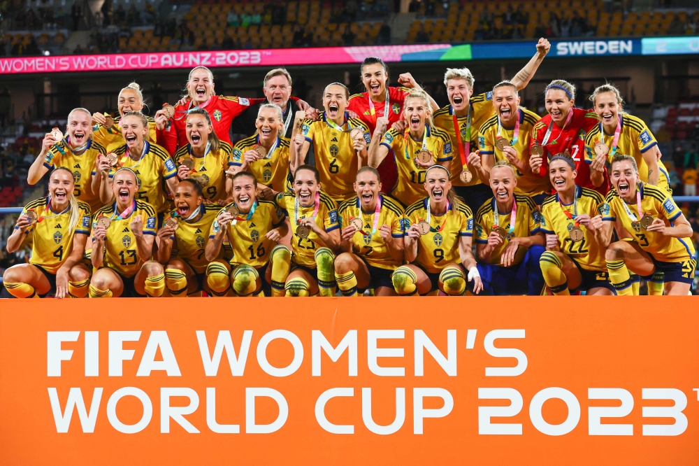 Sweden players celebrate with their bronze medals after winning the Australia and New Zealand 2023 Women's World Cup third place play-off football match between Sweden and Australia at Brisbane Stadium in Brisbane on August 19, 2023. Photos by Patrick Hamilton / AFP