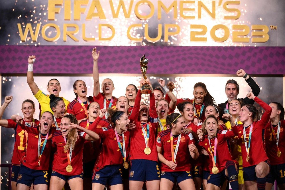 Spain's players celebrate with the trophy after winning the Australia and New Zealand 2023 Women's World Cup final football match between Spain and England at Stadium Australia in Sydney on August 20, 2023. Photo by FRANCK FIFE / AFP