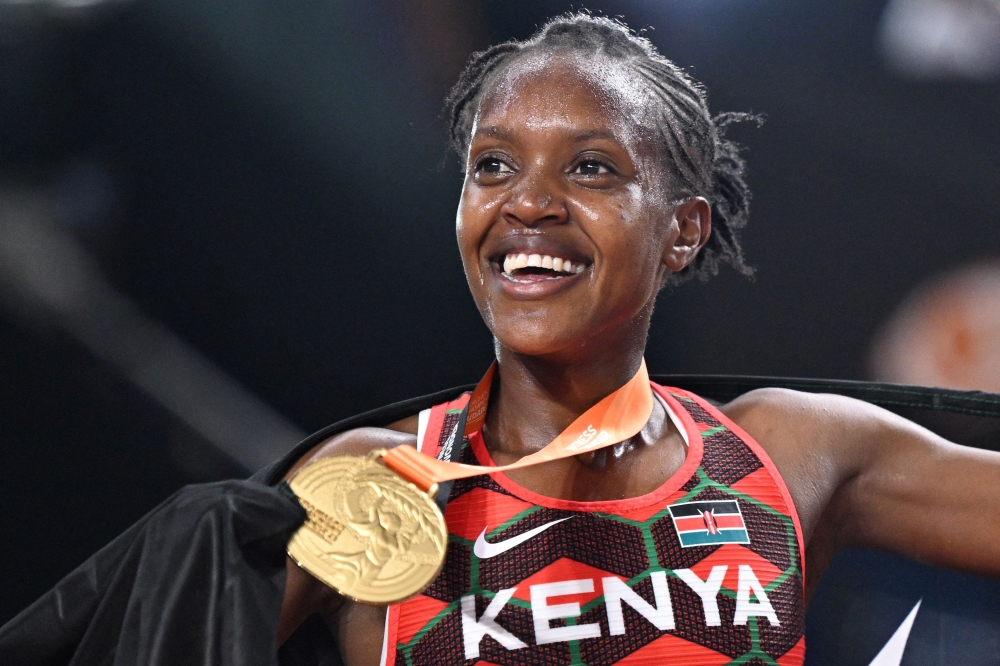 First-placed Kenya's Faith Kipyegon celebrates with her gold medal after winning the women's 1500m final during the World Athletics Championships at the National Athletics Centre in Budapest on August 22, 2023. (Photo by Kirill KUDRYAVTSEV / AFP)
