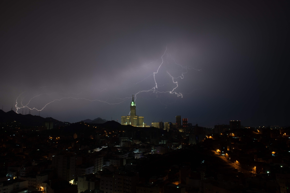 A picture taken on August 22, 2023 shows lightning over Makkah's clock tower in Saudi Arabia. Photos by Hammad Al-Huthali / AFP