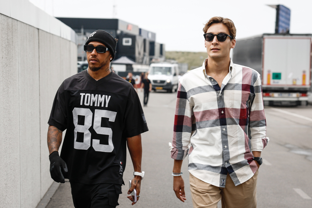 Mercedes' British drivers, Lewis Hamilton (L) and George Russell (R) arrive at the paddock of the Zandvoort Circuit ahead of the Dutch Formula One Grand Prix, in the coastal town of Zandvoort on August 24, 2023. Photo by Simon Wohlfahrt / AFP