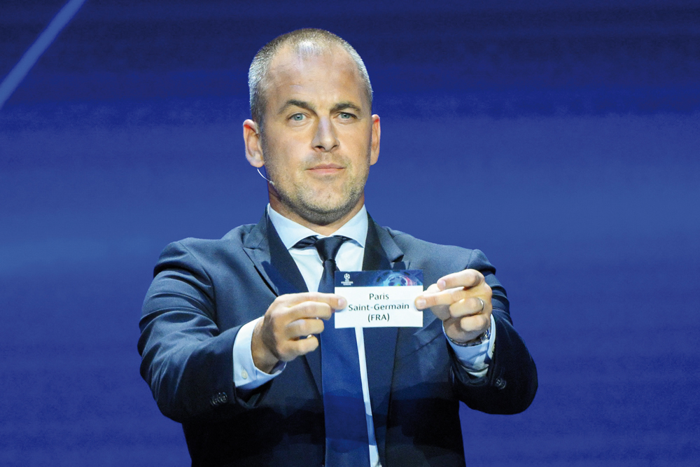 English former football player Joe Cole shows the paper slip of Paris Saint-Germain during the draw for the 2023/2024 UEFA Champions League yesterday. AFP