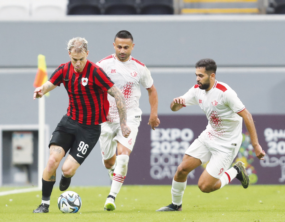 Al Rayyan's Roger Guedes in action with two Al Shamal players during their match at Al Bayt Stadium. Pic: Mahmoud Hefnawy