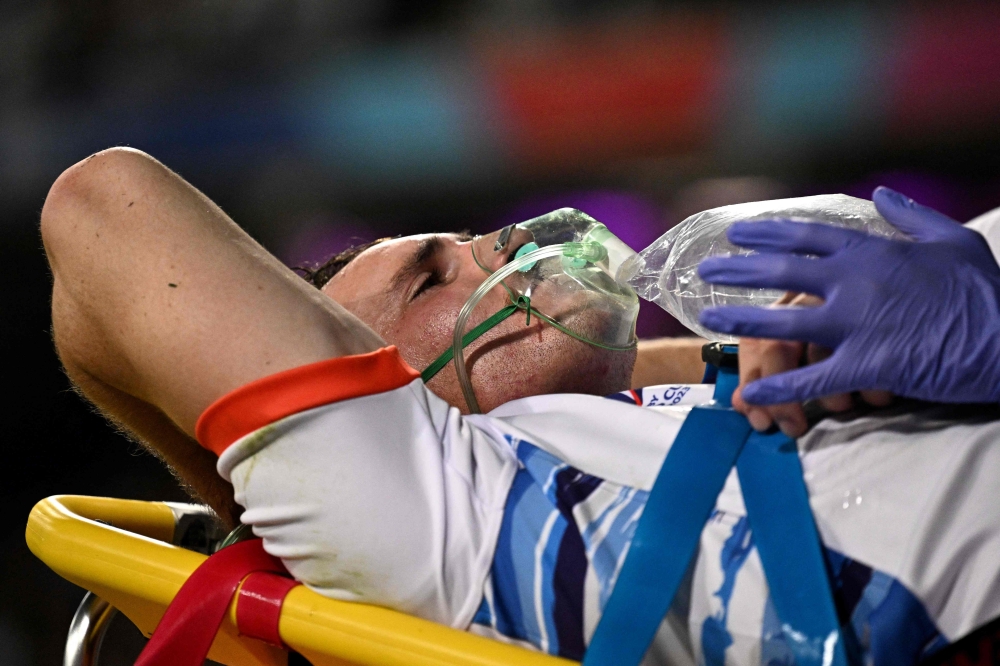 A medical official assists Namibia's inside center Le Roux Malan as he is moved from the pitch after suffering an injury during the France 2023 Rugby World Cup Pool A match between New Zealand and Namibia at Stadium de Toulouse in Toulouse, south-western France on September 15, 2023. (Photo by Lionel BONAVENTURE / AFP)
