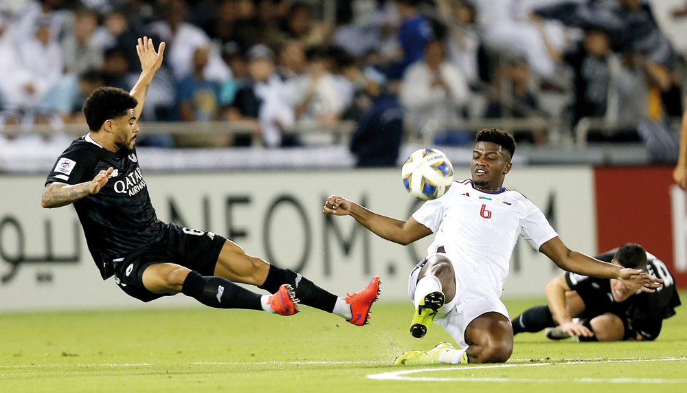 Al Sadd's Paulo Otávio (left) vies for the ball with Sharjah’s Majid Surour during the AFC Champions League Group B match at Jassim Bin Hamad Stadium in Doha, yesterday. Picture: AMR DIAB