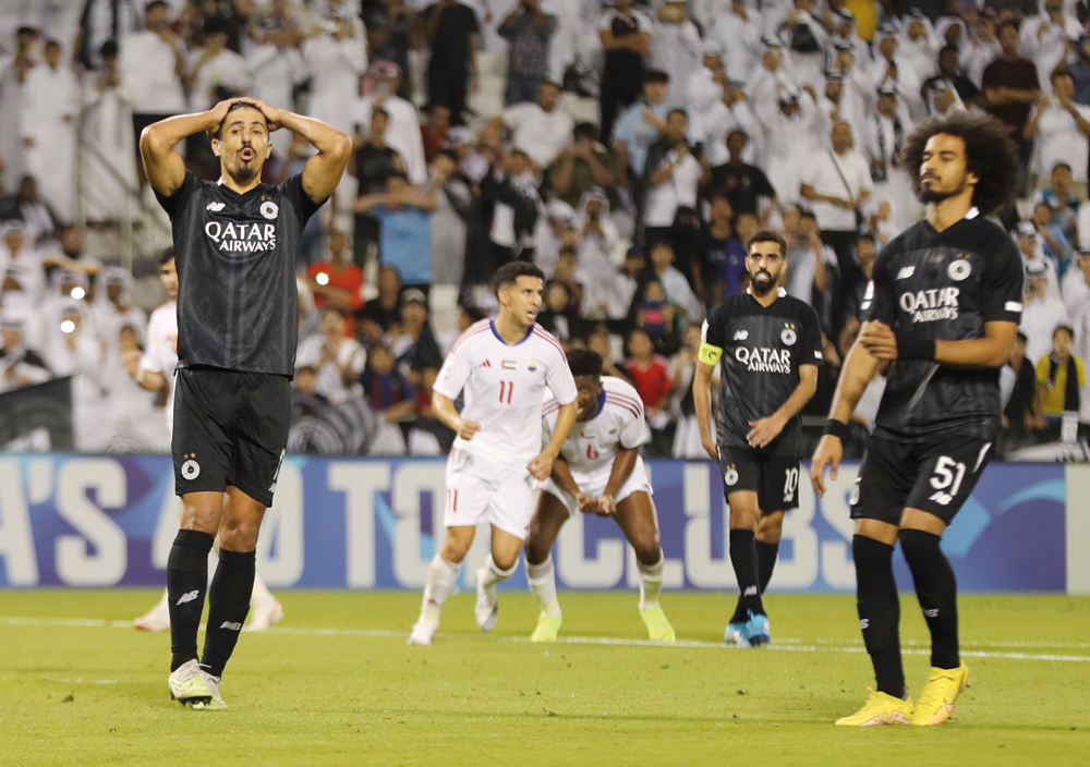 Al Sadd's Baghdad Bounedjah (left) reacts after missing a penalty during Monday's match.