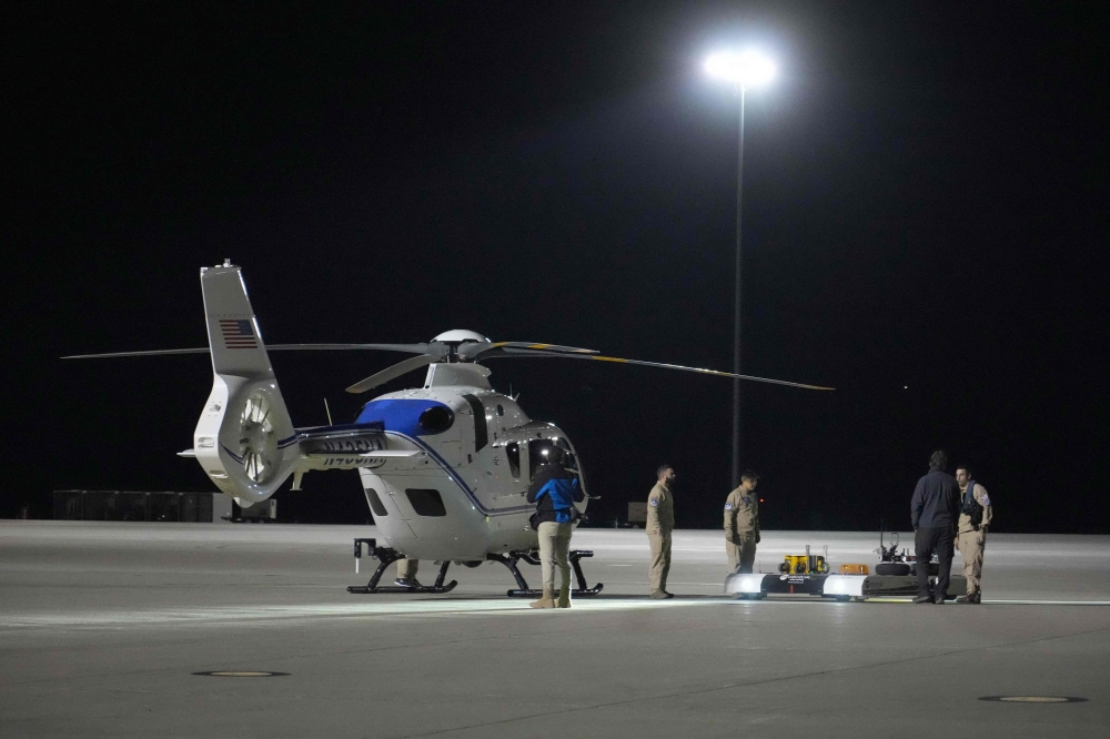 Crews move one of the helicopters that will participate in the Osiris-Rex asteroid sample return recovery mission out of a hanger at Dugway, Utah early September 24, 2023. (Photo by George Frey / AFP)