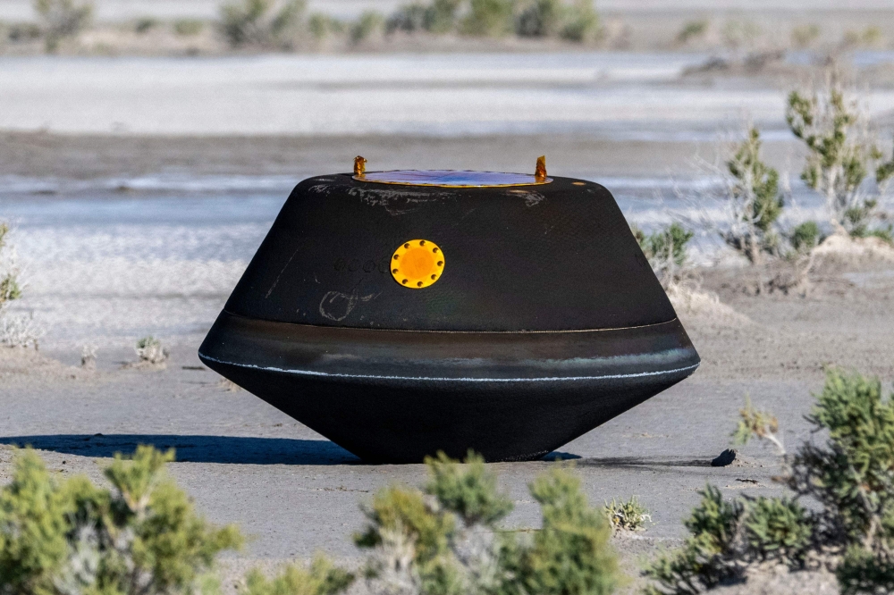 The sample return capsule from NASA's OSIRIS-REx mission is seen shortly after touching down in the desert on September 24, 2023 at the Department of Defense's Utah Test and Training Range in Dugway, Utah. (Photo by Keegan Barber / NASA / AFP)