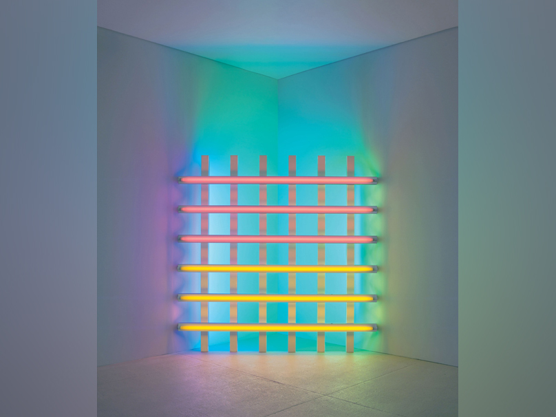 Dan Flavin, untitled (in honour of Harold Joachim) 3 (1977).__Pink, yellow, blue, and green fluorescent light, 8 ft. (244cm) square across a corner. The Dan Flavin Estate, Courtesy David Zwirner. © 2023 Stephen Flavin / Artists Rights Society (ARS), New York. Photo: Courtesy David Zwirner.
