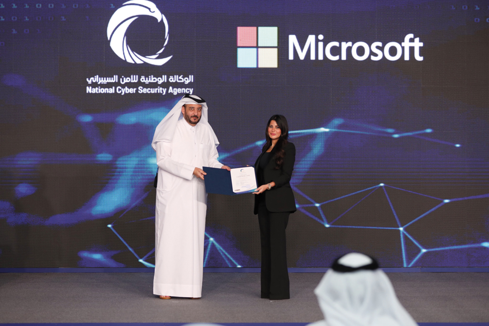 NCSA President Eng Abdulrahman bin Ali Al Farahid Al Malki presents the NCSA certification to Microsoft’s Lana Khalaf. 